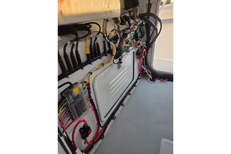 Slide: The Image of Electrical wiring inside 2022 Tidal Creeks Boatworks Center Console, showcasing organized cables and components. - 31