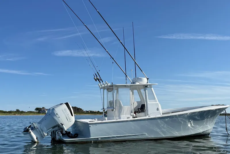 The Image of 2023 Tidal Creeks Boatworks Center Console on calm water, featuring multiple fishing rods. - 0