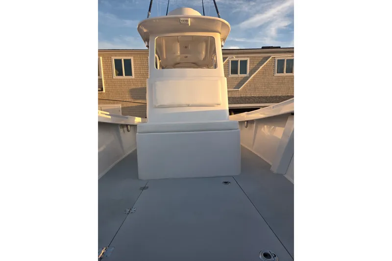 Slide: The Image of 2022 Tidal Creeks Boatworks Center Console, sleek design, docked under clear sky. - 42