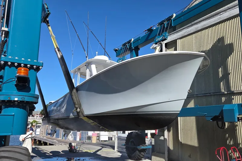 Slide: The Image of 2022 Tidal Creeks Boatworks Center Console being lifted by a boat hoist. - 23