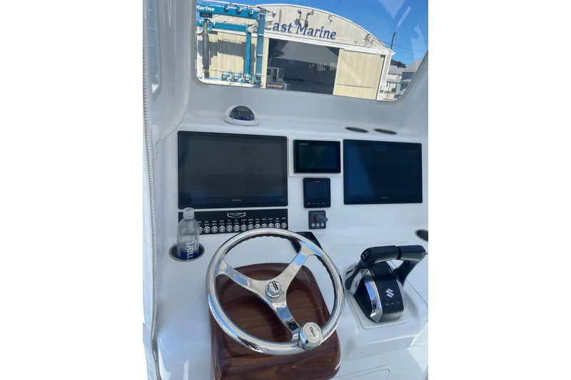 Slide: The Image of 2022 Tidal Creeks Boatworks Center Console dashboard with steering wheel and navigation screens. - 17