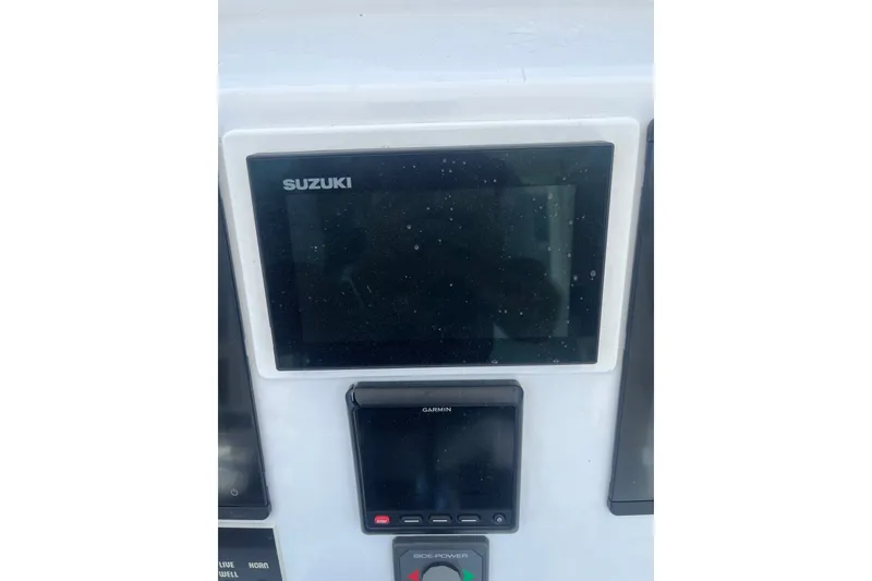 Slide: The Image of 2022 Tidal Creeks Boatworks Center Console dashboard with Suzuki and Garmin displays. - 13