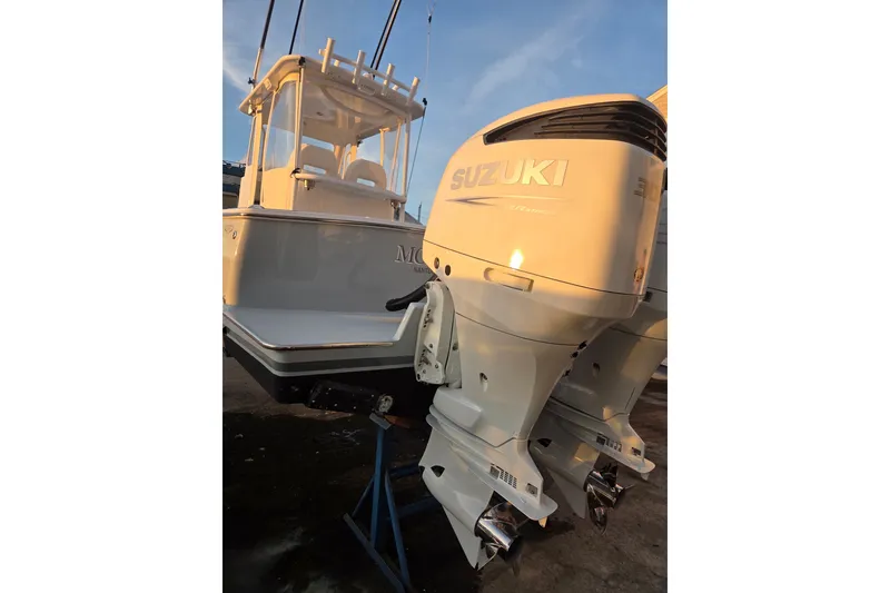 Slide: The Image of 2022 Tidal Creeks Boatworks Center Console with Suzuki outboard engines, docked at sunset. - 28