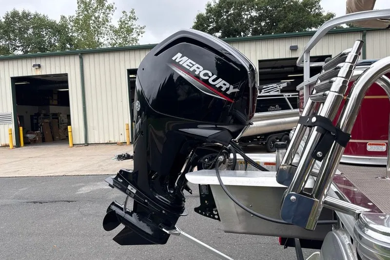 Slide: The Image of 2024 Sun Tracker Bass Buggy 18 DLX with Mercury outboard motor at a dealership. - 21