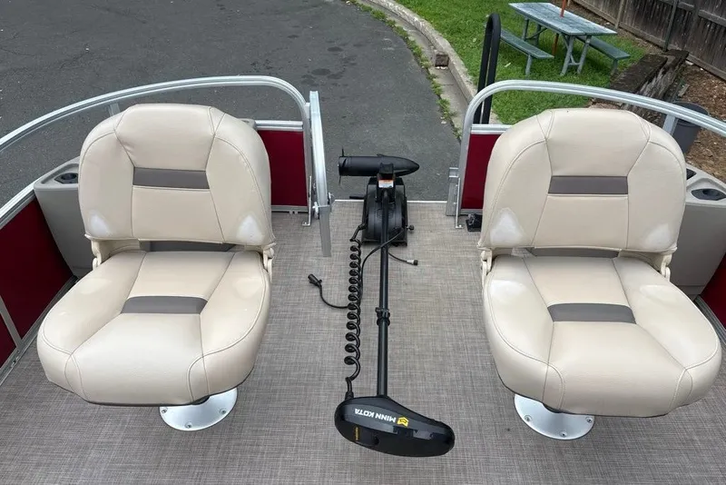 Slide: The Image of 2024 Sun Tracker Bass Buggy 18 DLX boat seats with trolling motor on deck. - 18
