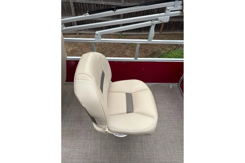 Slide: The Image of 2024 Sun Tracker Bass Buggy 18 DLX boat seat, beige upholstery, outdoor setting. - 15