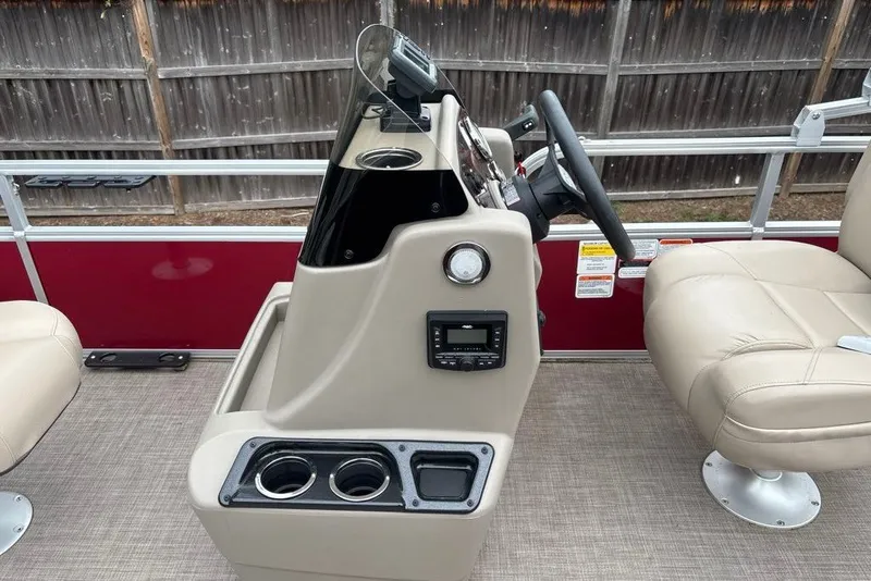 Slide: The Image of 2024 Sun Tracker Bass Buggy 18 DLX boat console with steering wheel and cup holders. - 13