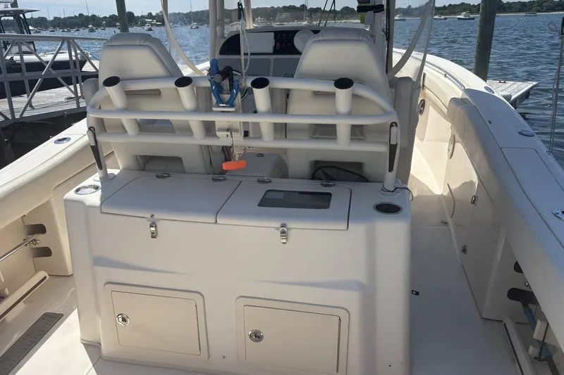 Slide: The Image of 2021 Grady-White Canyon 306 boat interior with rod holders and storage compartments. - 5