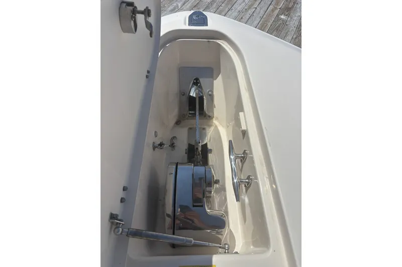 Slide: The Image of Anchor compartment of 2021 Grady-White Canyon 306 boat, featuring chrome fittings. - 11