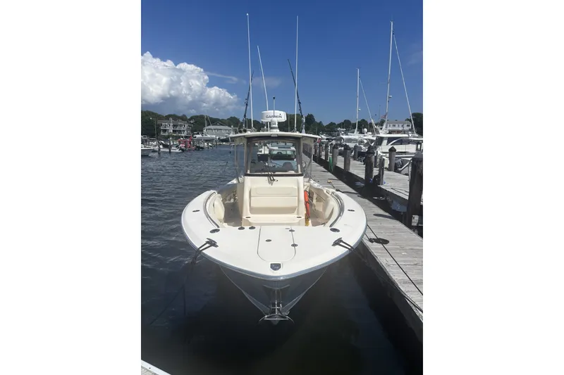 Slide: The Image of 2021 Grady-White Canyon 306 boat docked at marina under clear blue sky. - 20
