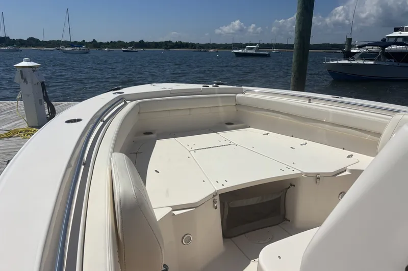 Slide: The Image of 2021 Grady-White Canyon 306 boat docked, showcasing spacious seating and sleek design. - 9