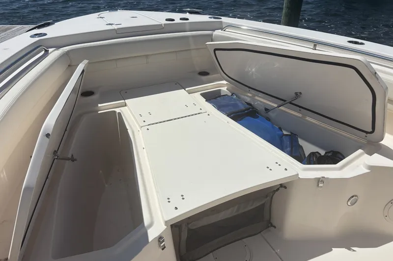 Slide: The Image of 2021 Grady-White Canyon 306 boat interior with open storage compartment. - 19