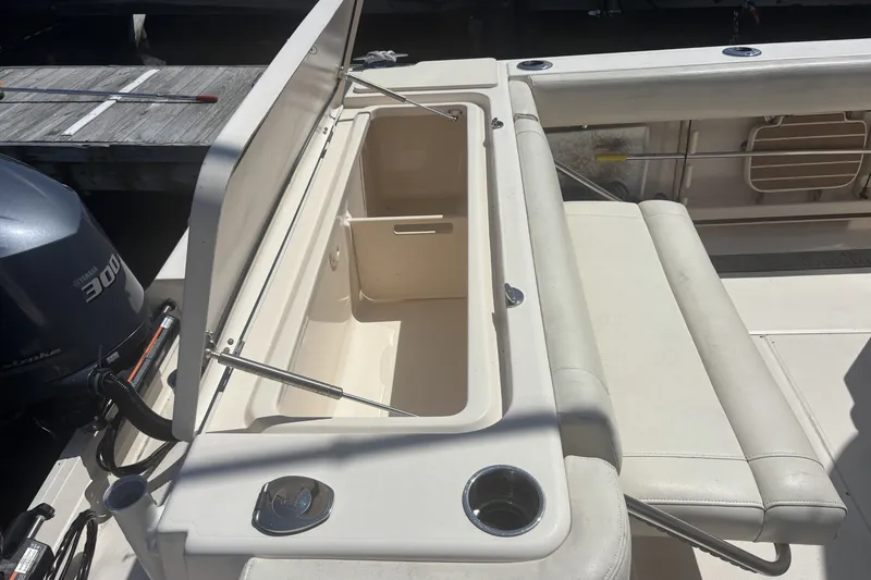 Slide: The Image of 2021 Grady-White Canyon 306 boat interior with open storage compartment and Yamaha 300 engine. - 14