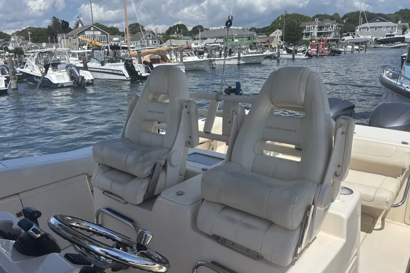 Slide: The Image of 2021 Grady-White Canyon 306 boat interior with plush seating at marina. - 3