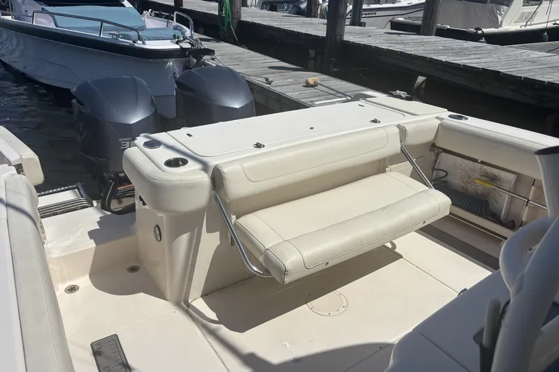 Slide: The Image of 2021 Grady-White Canyon 306 boat with dual outboard engines docked at marina. - 17