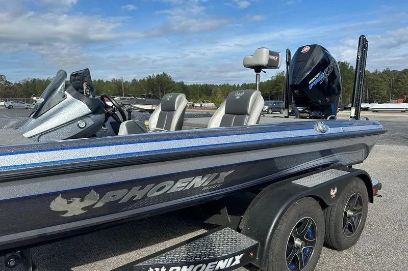 Slide: The Image of 2021 Phoenix 920 Elite boat with sleek design and powerful engine on a trailer. - 13