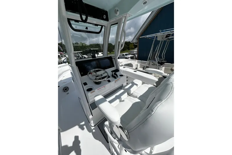 Slide: The Image of 2026 Sportsman Open 232 Center Console boat interior with steering wheel and seating. - 6