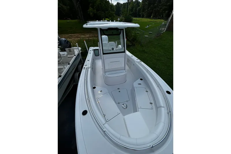 Slide: The Image of 2026 Sportsman Open 232 Center Console boat with sleek white design and spacious seating. - 4