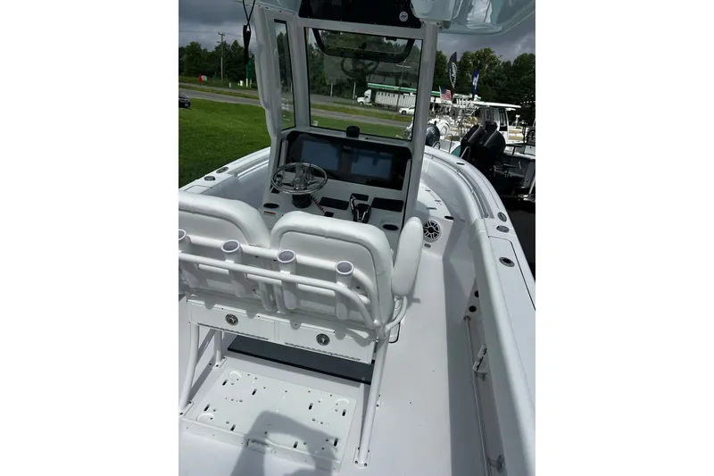 Slide: The Image of 2026 Sportsman Open 232 Center Console boat interior with steering wheel and seating. - 2