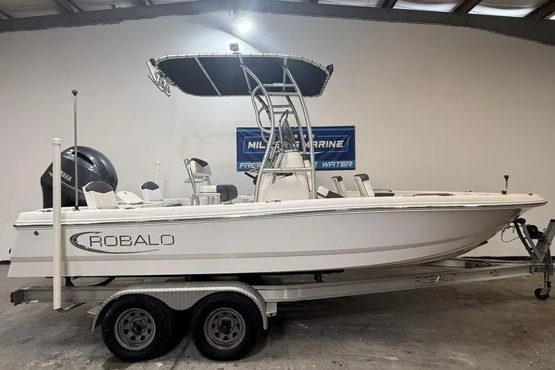 The Image of 2020 Robalo 206 Cayman boat on trailer in indoor showroom. - 0