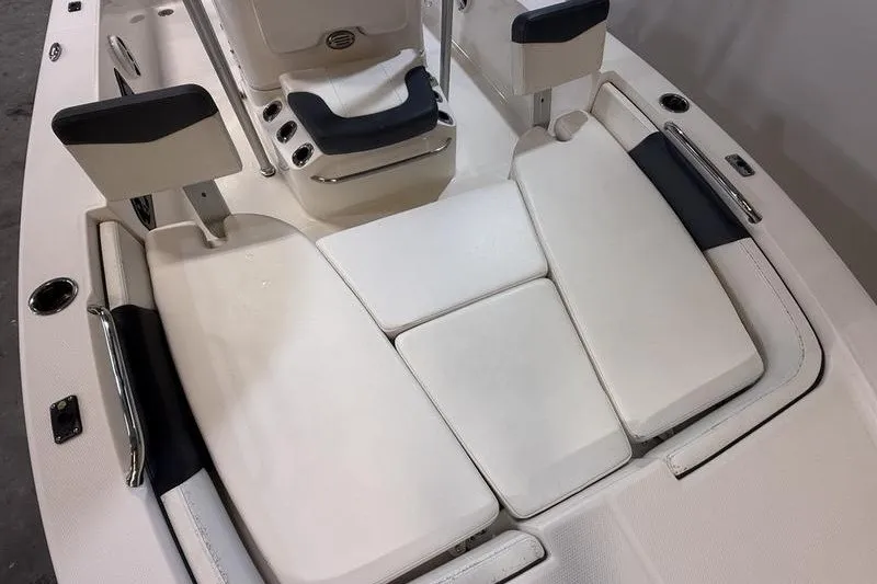 Slide: The Image of 2020 Robalo 206 Cayman boat interior with white cushioned seating. - 14