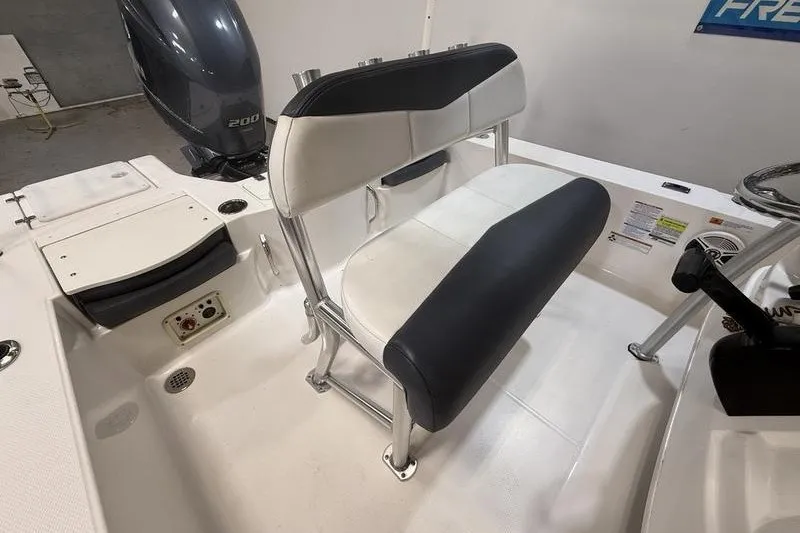 Slide: The Image of 2020 Robalo 206 Cayman boat interior with seating and motor detail. - 9