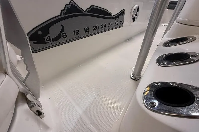 Slide: The Image of 2020 Robalo 206 Cayman boat interior with fish ruler and rod holders. - 13