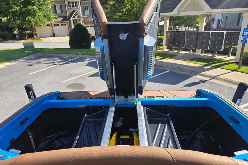 Slide: The Image of 2021 Centurion Ri257 boat interior with open engine compartment in a residential area. - 21
