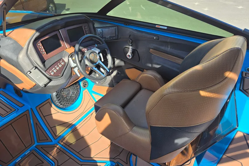 Slide: The Image of 2021 Centurion Ri257 boat interior with steering wheel and control panel. - 16