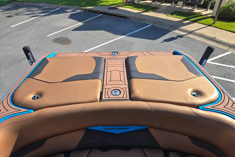 Slide: The Image of 2021 Centurion Ri257 boat with tan and black seating in a parking lot. - 18