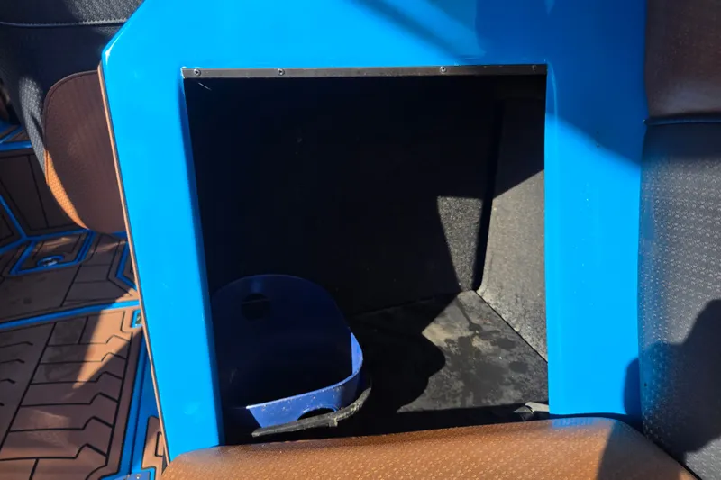 Slide: The Image of Storage compartment in a 2021 Centurion Ri257 boat, featuring blue and brown interior accents. - 24