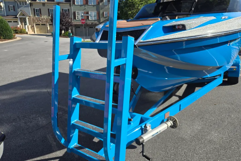 Slide: The Image of Blue 2021 Centurion Ri257 boat on trailer with ladder, parked in residential area. - 26