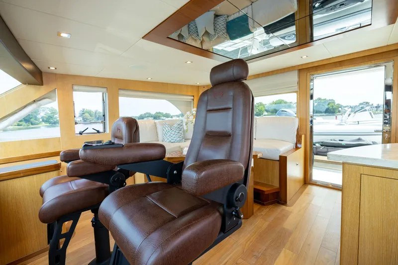 Slide: The Image of Luxurious interior of 2019 Horizon PC65 yacht with leather seating and panoramic windows. - 21