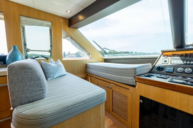 Slide: The Image of Luxurious interior of 2019 Horizon PC65 yacht with modern seating and navigation controls. - 19