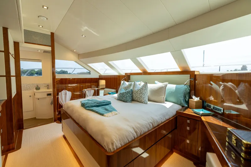Slide: The Image of Luxurious bedroom interior on 2019 Horizon PC65 yacht with elegant wood finishes and skylight. - 34