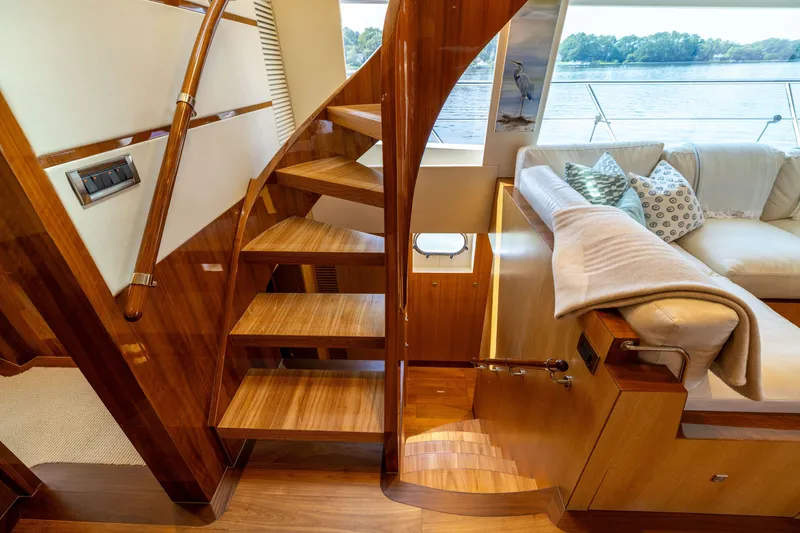 Slide: The Image of Luxurious wooden staircase and seating area inside 2019 Horizon PC65 yacht. - 23
