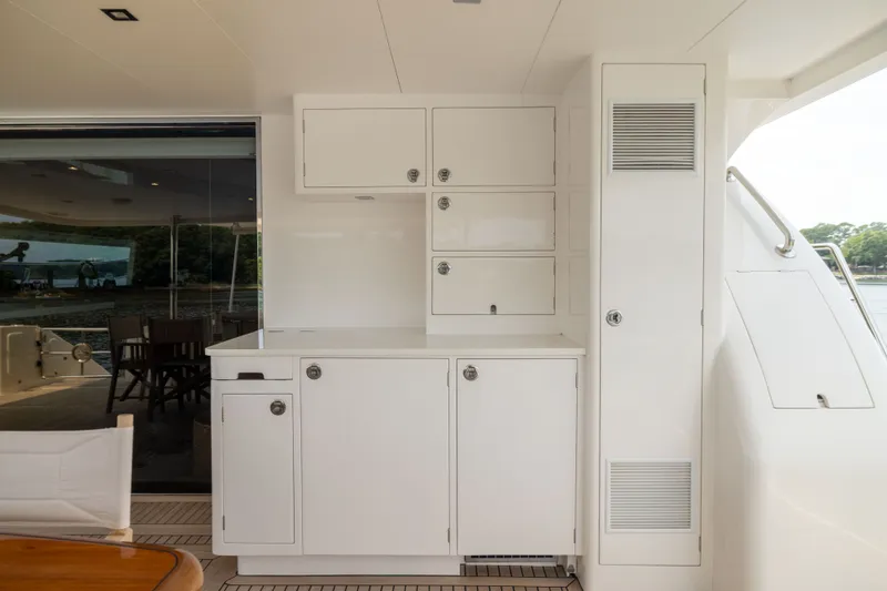 Slide: The Image of Luxurious 2019 Horizon PC65 yacht interior with sleek white cabinetry and outdoor seating area. - 9