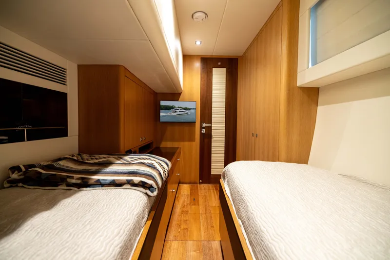 Slide: The Image of Luxurious 2019 Horizon PC65 yacht cabin with twin beds and modern wood finish. - 47