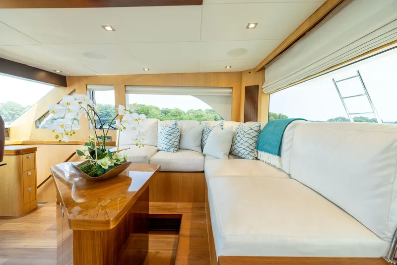 Slide: The Image of Luxurious interior of 2019 Horizon PC65 yacht with elegant seating and floral decor. - 15