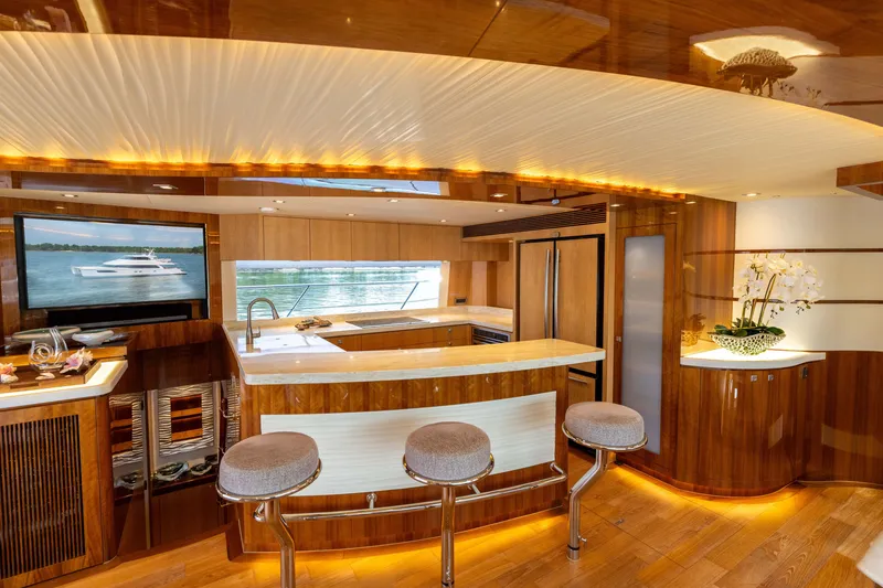 Slide: The Image of Luxurious 2019 Horizon PC65 yacht interior with modern kitchen and elegant wooden finishes. - 30