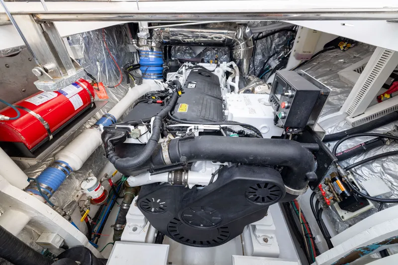 Slide: The Image of Engine room of a 2019 Horizon PC65 yacht, featuring advanced machinery and safety equipment. - 54
