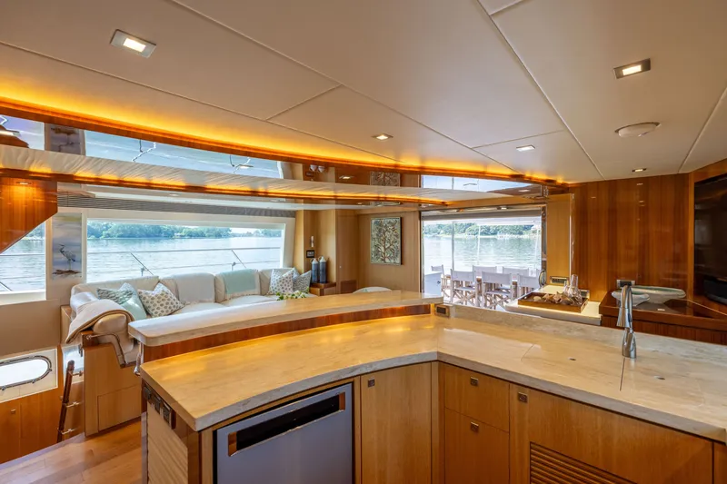 Slide: The Image of Luxurious interior of 2019 Horizon PC65 yacht with elegant wood finishes and scenic water views. - 29