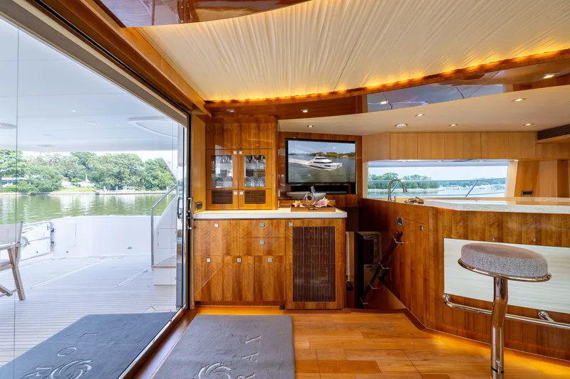 Slide: The Image of Luxurious 2019 Horizon PC65 yacht interior with wooden finishes and scenic water views. - 24
