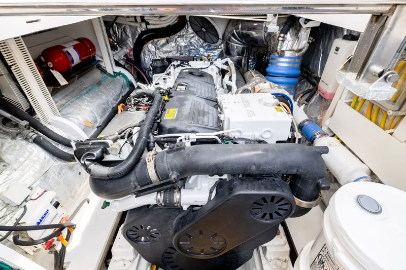 Slide: The Image of Engine room of a 2019 Horizon PC65 yacht, showcasing detailed mechanical components. - 51