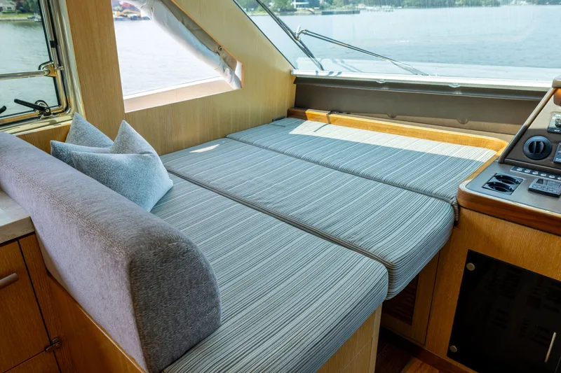 Slide: The Image of Luxurious interior of 2019 Horizon PC65 yacht with comfortable seating and scenic window view. - 18