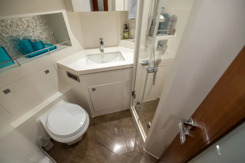 Slide: The Image of Modern bathroom in 2019 Horizon PC65 yacht with shower, sink, and toilet. - 45