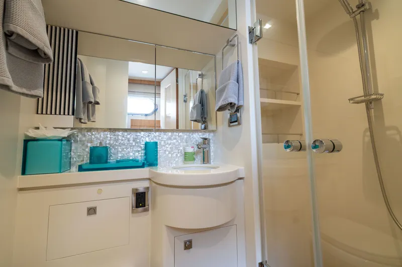 Slide: The Image of Modern bathroom on 2019 Horizon PC65 yacht with sleek fixtures and glass shower. - 48