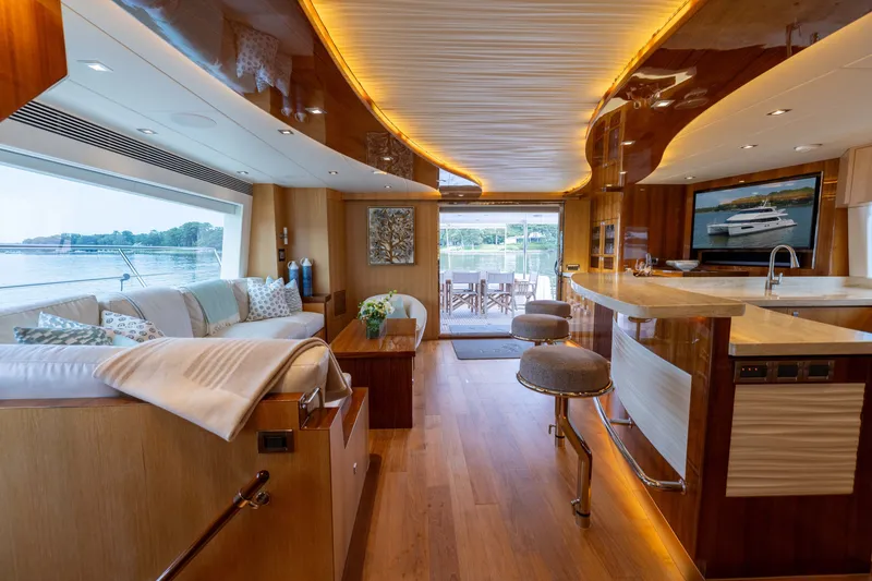 Slide: The Image of Luxurious 2019 Horizon PC65 yacht interior with elegant seating, bar, and scenic window views. - 26