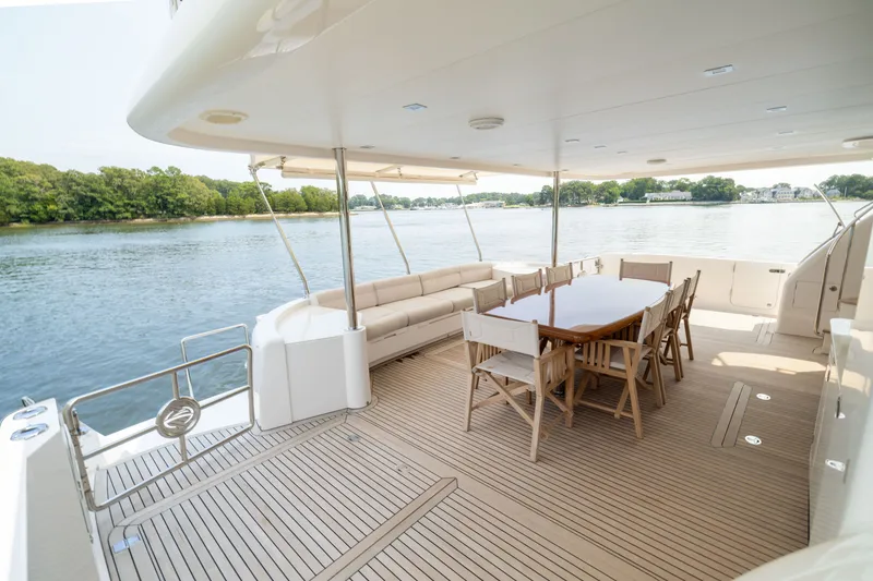 Slide: The Image of Spacious deck of 2019 Horizon PC65 yacht with dining area and scenic water view. - 8