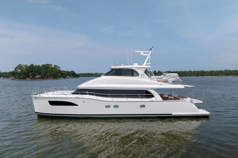 Slide: The Image of 2019 Horizon PC65 yacht cruising on a calm lake under a clear blue sky. - 1